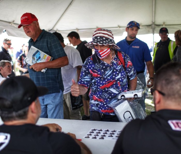 A fan gives Tony Stewart the thumbs up in the autograph signing tent