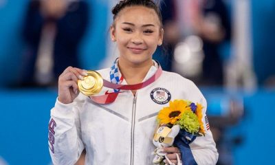 suni lee holding her gold medal