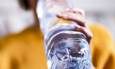 woman drinking mineral water from the bottle