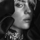 billie eilish is shown with a bejeweled coat framing her face