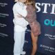 justin and hailey bieber kissing on a red carpet