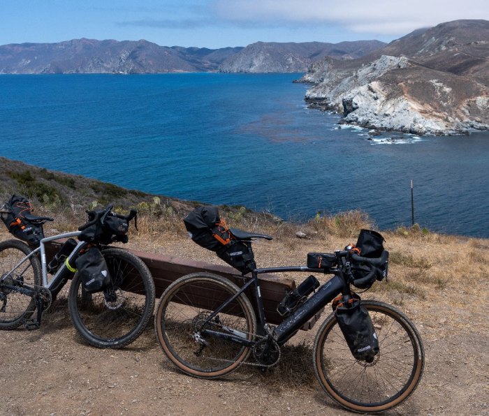 Handlebar packs on bikes with California coast in background