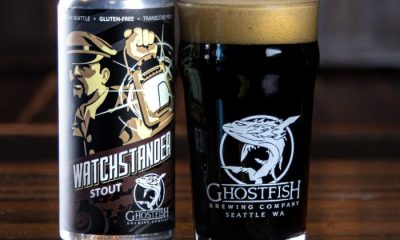 Tall can and filled pint glass of gluten-free Ghostfish Brewing Company Watchstander Stout