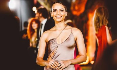 leslie grace poses in a taupe cutout gown