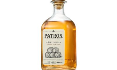 Bottle of Patrón Sherry Cask Aged Añejo Tequila on a brown table