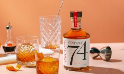 Bottle of Spiritless Kentucky 74 on a table with mixing glass