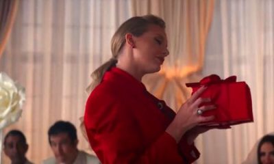 taylor swift holding a red present in the i bet you think about me music video