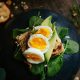 Hard boiled eggs on toast with spinach