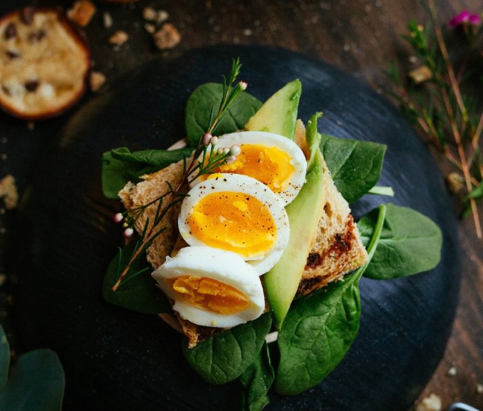 Hard boiled eggs on toast with spinach