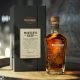 Bottle of Wild Turkey Master’s Keep One next to black box container on wooden table