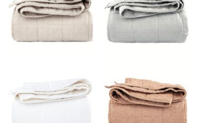 Four folded Bokser Home French linen quilts: white, gray, beige and brown