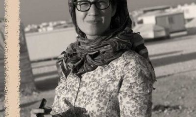 lauren wolfe holds a notepad while working as a journalist in the zaatari refugee camp in jordan