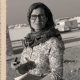 lauren wolfe holds a notepad while working as a journalist in the zaatari refugee camp in jordan