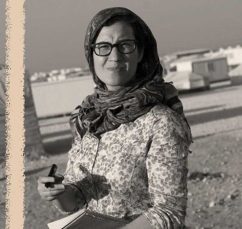 lauren wolfe holds a notepad while working as a journalist in the zaatari refugee camp in jordan