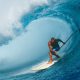 Laird Hamilton riding big wave on paddleboard with paddle