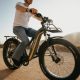 Man riding an Aventon Aventure Ebike on a dirt road