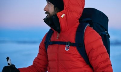 Man wearing a red Expedition Pack Down Hoodie