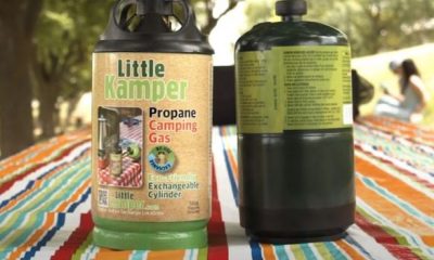 Two Little Kamper fuel cannisters on a picnic table at a campground