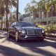 Black 2022 Bentley Flying Spur Hybrid driving through Beverly Hills, CA