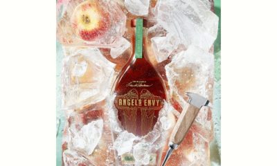 Bottle of Angel's Envy Ice Cider Cask in ice block with apples