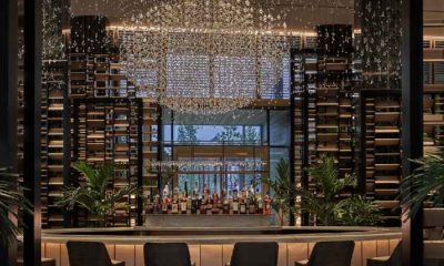 Row of chairs facing the bar and window at Chandelier Bar