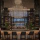 Row of chairs facing the bar and window at Chandelier Bar