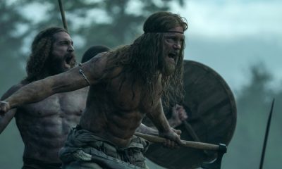 A shirtless Alexander Skårsgard doing battle as a Viking warrior in The Northman.