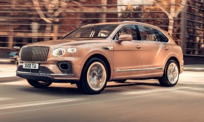 Rose colored 2023 Bentley Bentayga Extended Wheelbase, front side, driving on the road