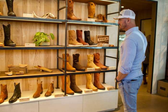 Mike Sarraille browsing boots at Tecovas boot shop in Austin, TX.