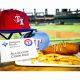 Corn dog with French fries on late with baseball hats and stadium in background