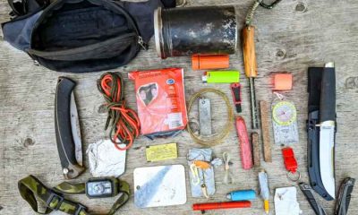 Jim Baird's survival kit laid out on a wooden table, viewed from the above.