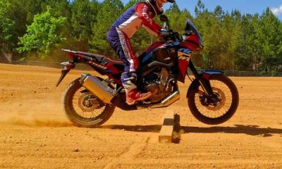 Riding motorcycle on dirt over obstacle