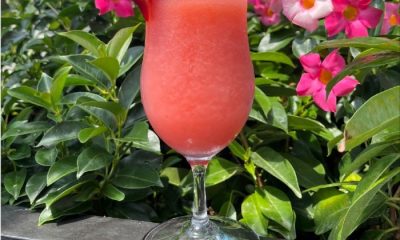Frosé cocktail on a ledge with floral background
