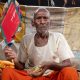 Raja Ram, 97, fans himself with a handmade fan