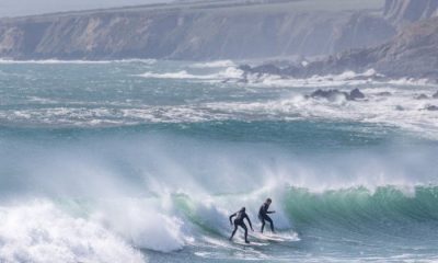 Two surfers on a wave on Ireland's west coast.