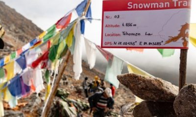 Snowman Trek signage and flags on mountainside