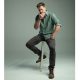 Actor Chris Hemsworth posing in green button-down on stool