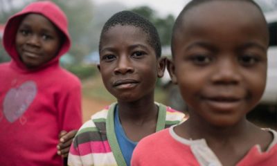 Three Malawian children looking directly into camera